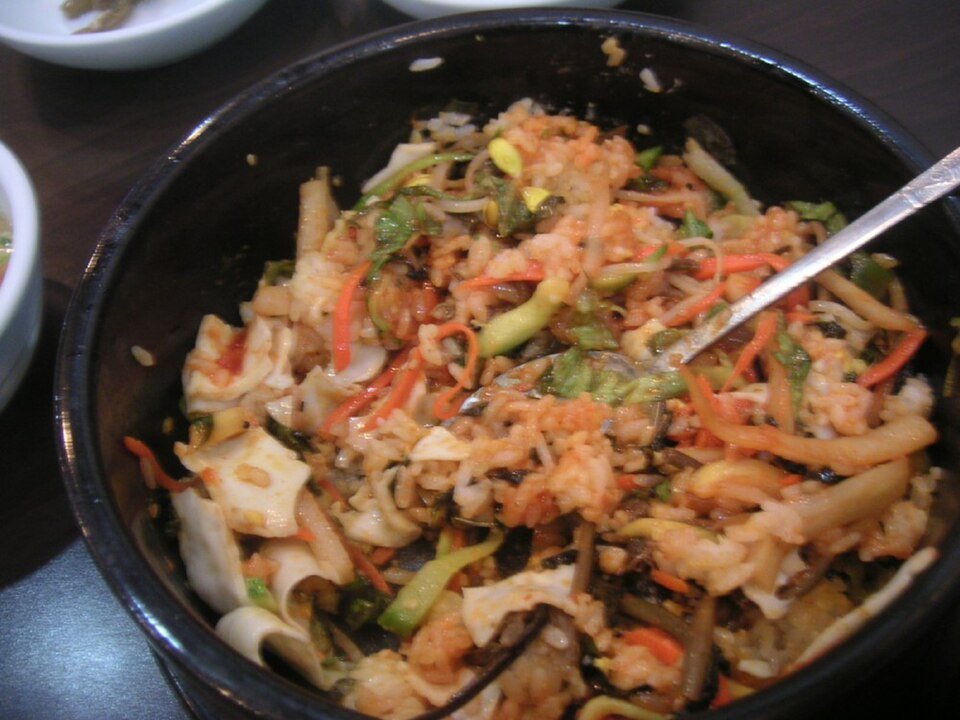 Bibimbap stirred together with gochujang red pepper paste before eating