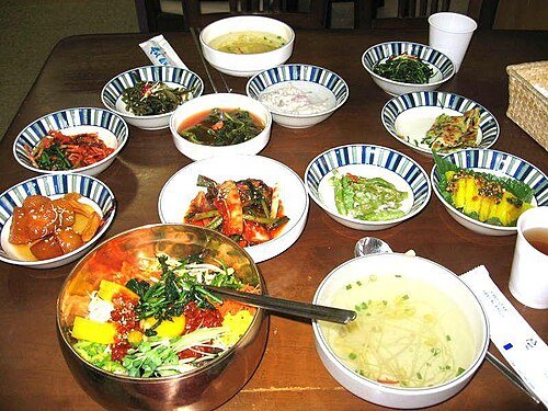 Bibimbap served with Korean banchan side dishes and soup