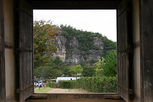 Buyongdae cliff seen through a hanok gate in Andong Hahoe Village
