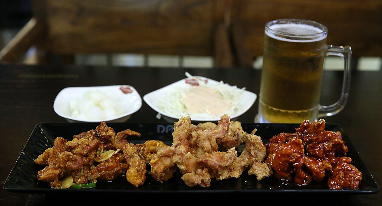 Korean fried chicken in Seoul style chimaek table with beer and side dishes