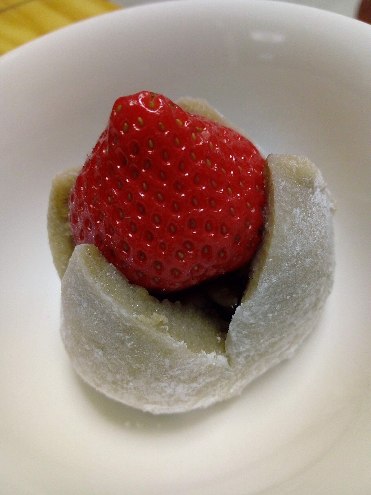 Fruit mochi with a whole strawberry on top of chewy rice cake
