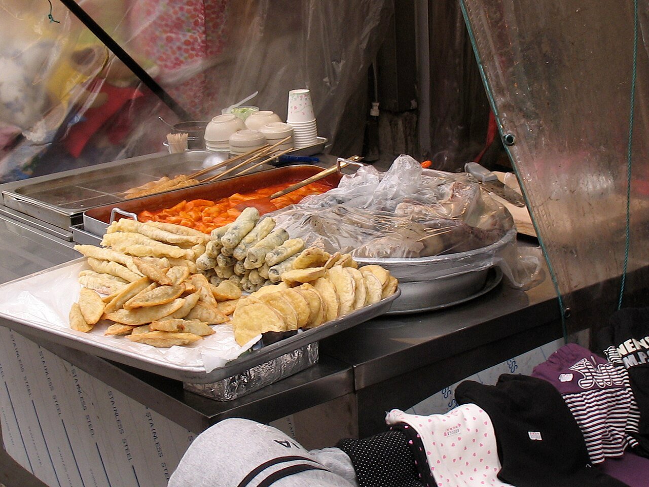 Korean street food stall with tteokbokki, twigim fritters and sundae