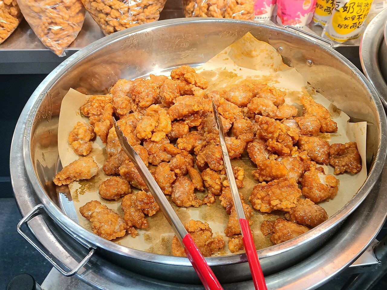 Korean fried chicken in Seoul with cheese seasoning served in a pan