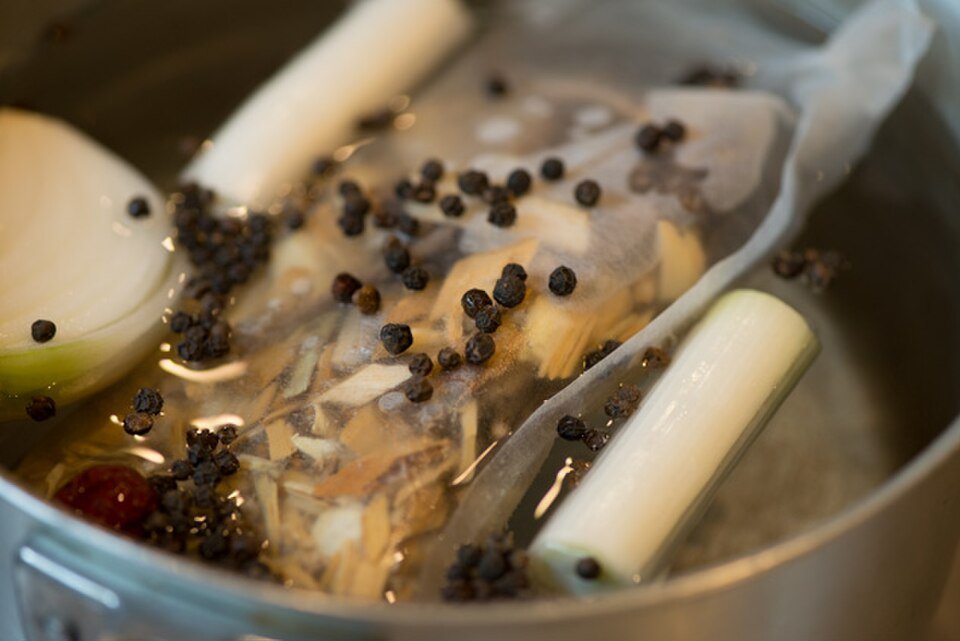 Milky samgyetang broth made by simmering chicken with ginseng and garlic