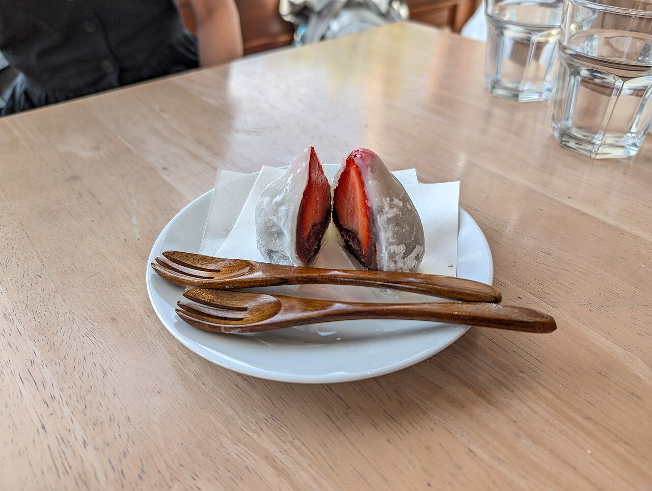 Jumbo strawberry mochi served on a plate at a dessert cafe
